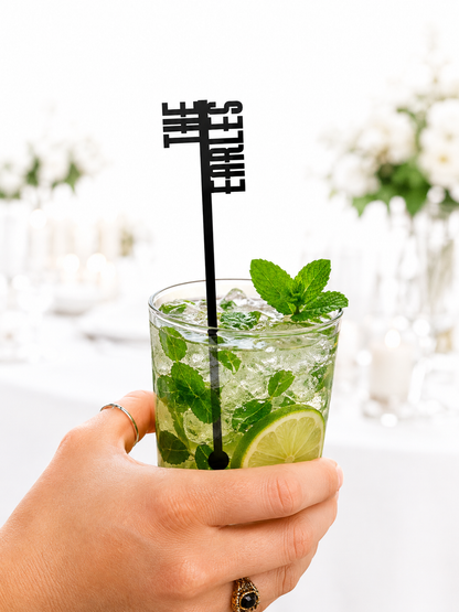 Black vertical name stir stick in a mojito at a wedding reception