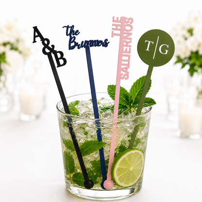 Personalized black, navy, pink and olive green drink stirrers with initials and names in a mojito at a wedding table