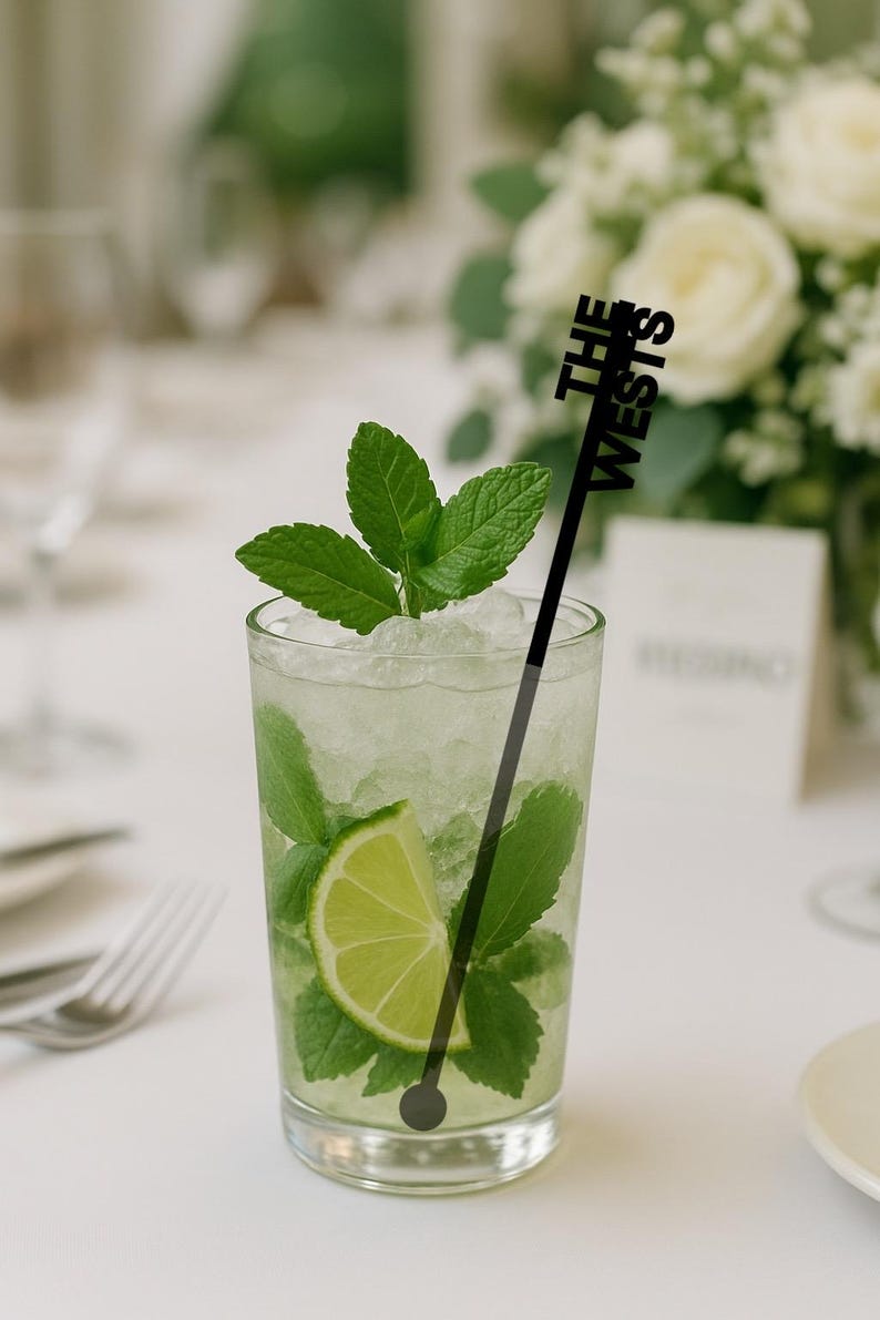 Black vertical name stir stick in a mojito on a wedding table